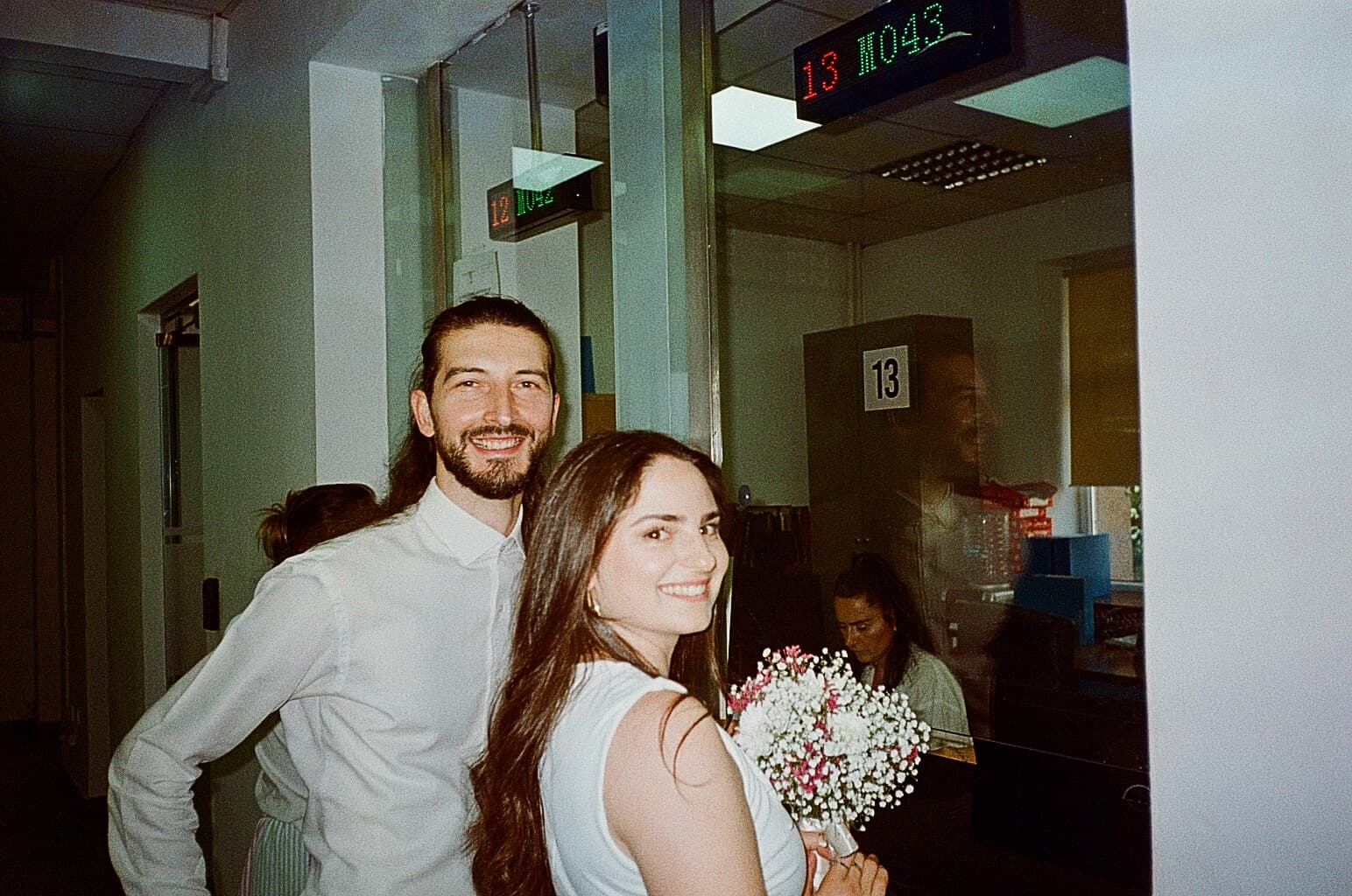 Bardha and Arben smiling at each other on the steps