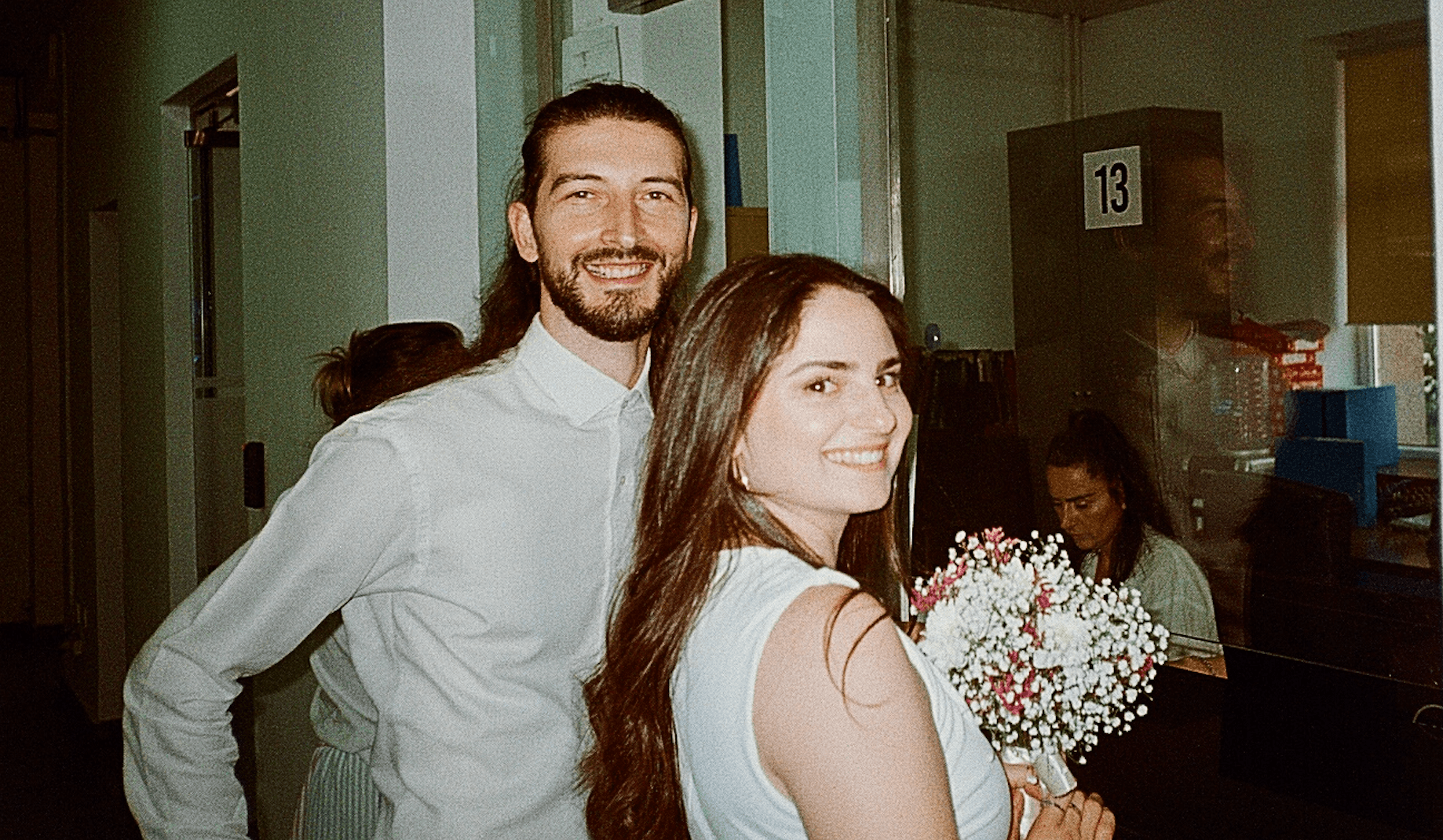 Bardha and Arben celebrating with a bottle of bubbly