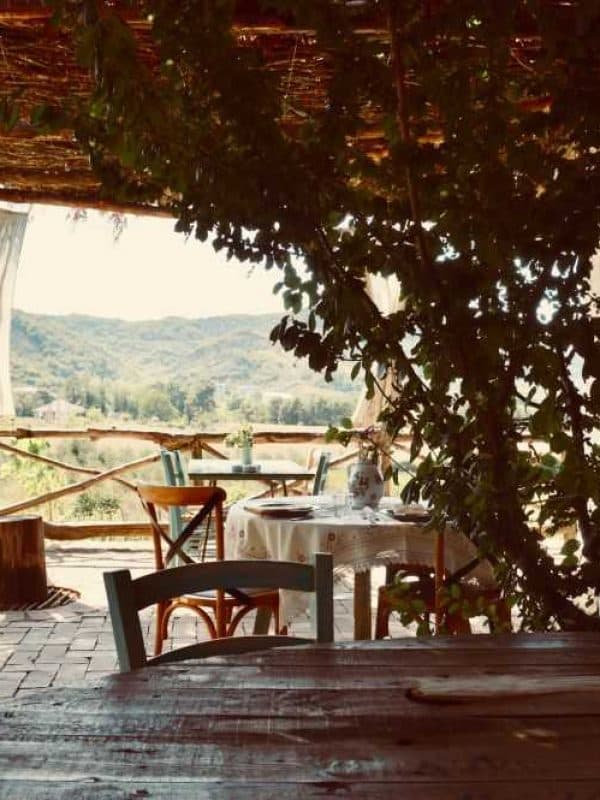 Shaded pergola terrace at Fustanella Farm overlooking the hills